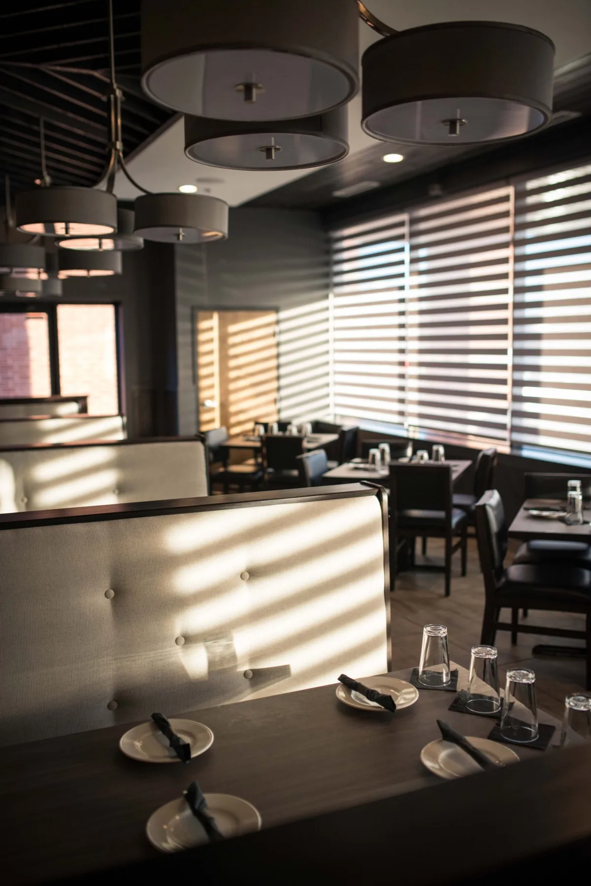 Banquette seating in the warmly lit L.A. Bistro Canton dining room